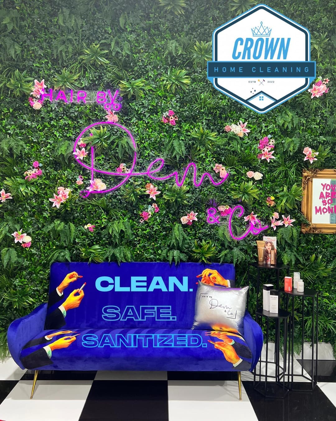 Vibrant salon interior featuring a blue couch, floral wall, and "CLEAN. SAFE. SANITIZED." sign.