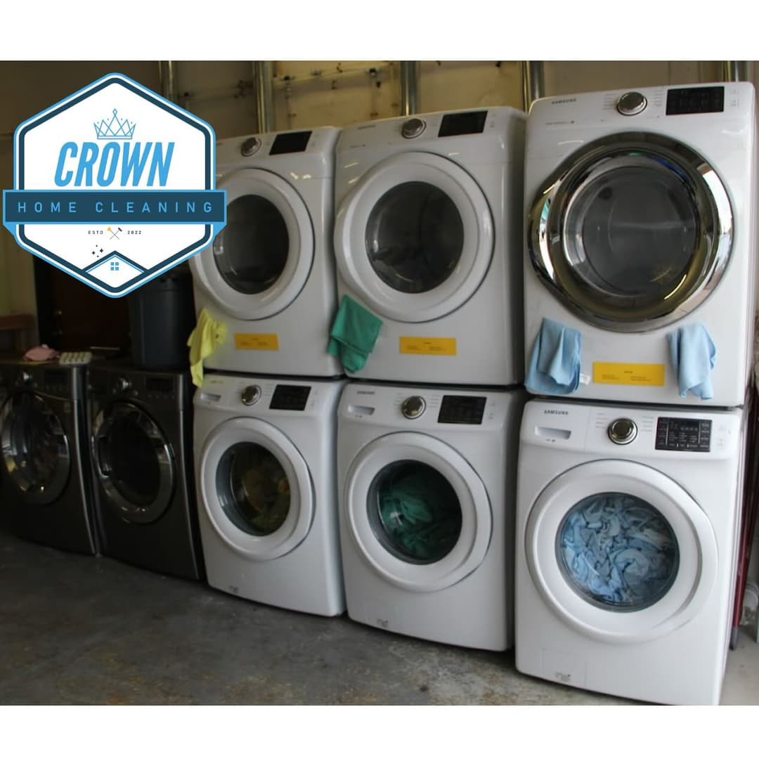 Stacked washing machines and dryers in a home cleaning environment with Crown logo.