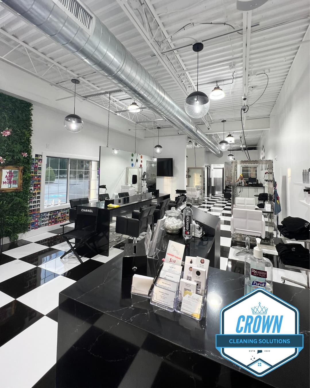 Modern cleaning solutions studio with black and white checkered floor, featuring sleek decor.